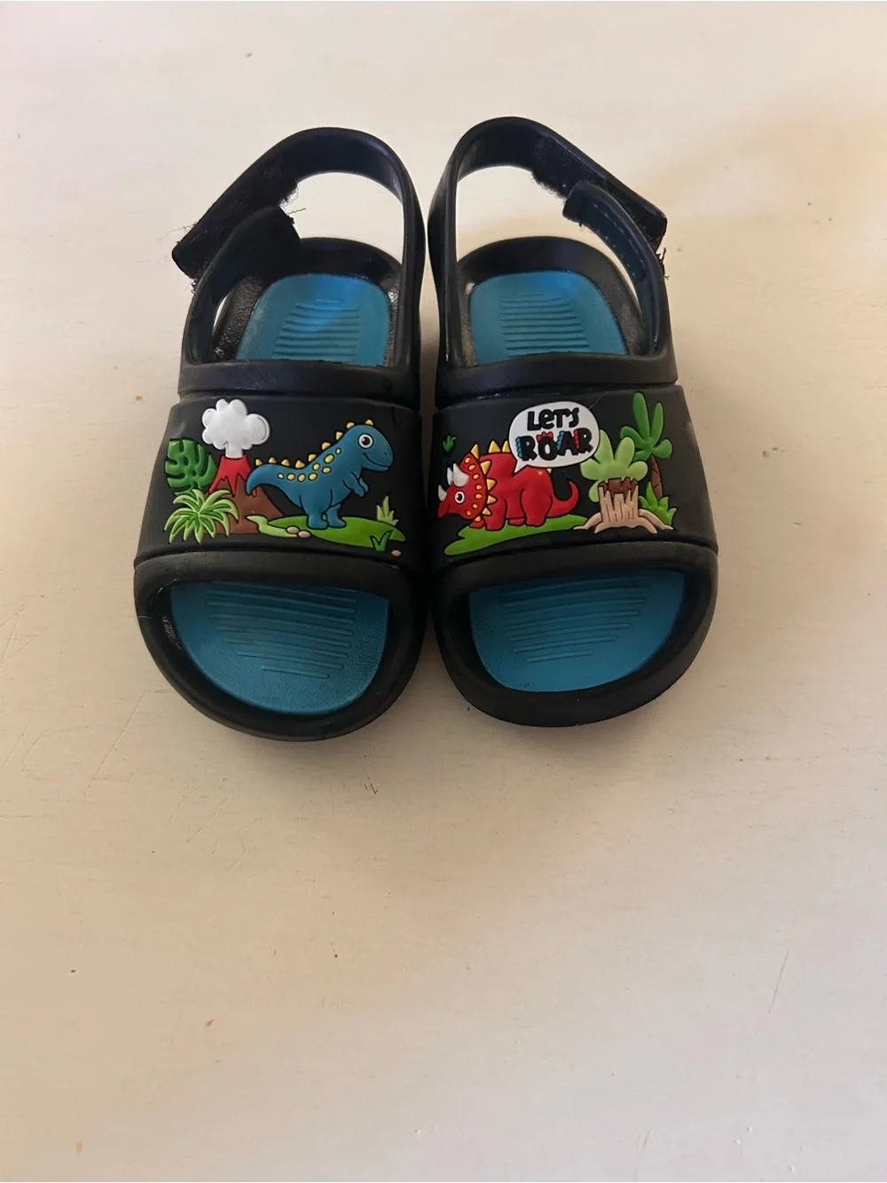 CROCS Black Kids Sandals with Blue Insole and Dino Accents
